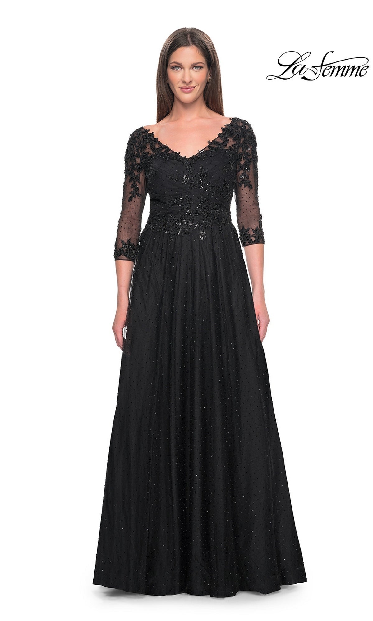 A model wearing a Long Formal Dress: La Femme 31776, a black floor-length gown featuring a V-neckline, three-quarter length sleeves, and lace and sequin detailing on the bodice.